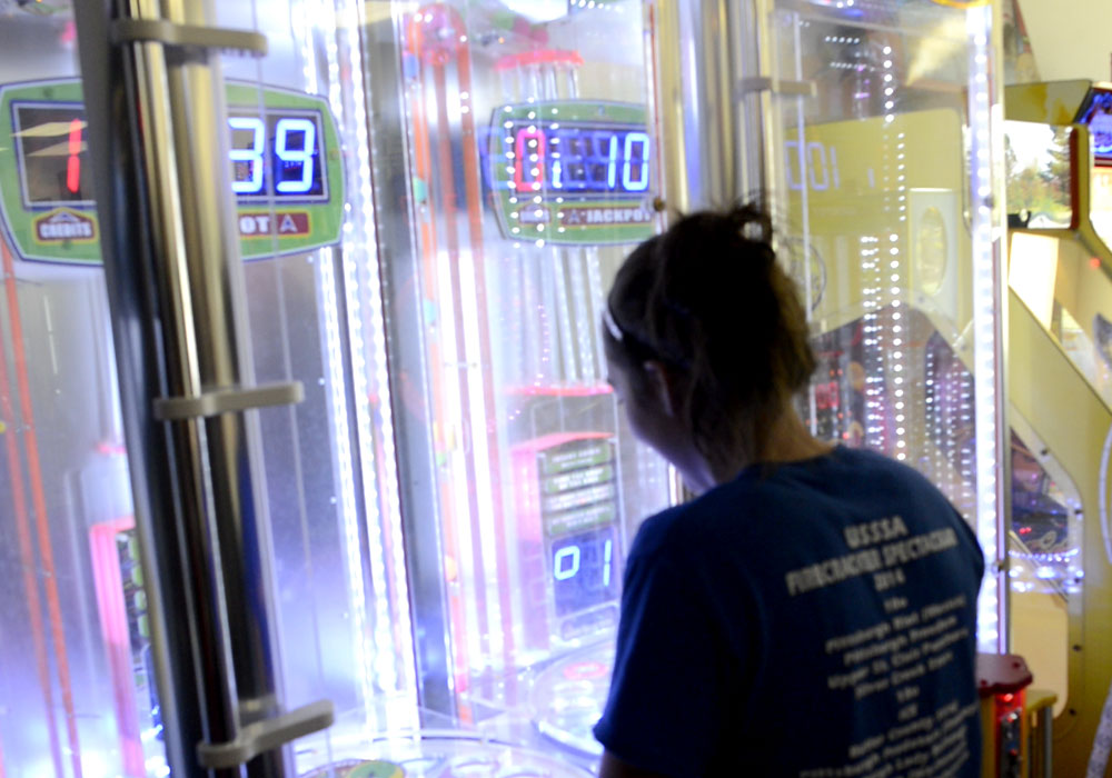 Young Lady Playing Arcade Game
