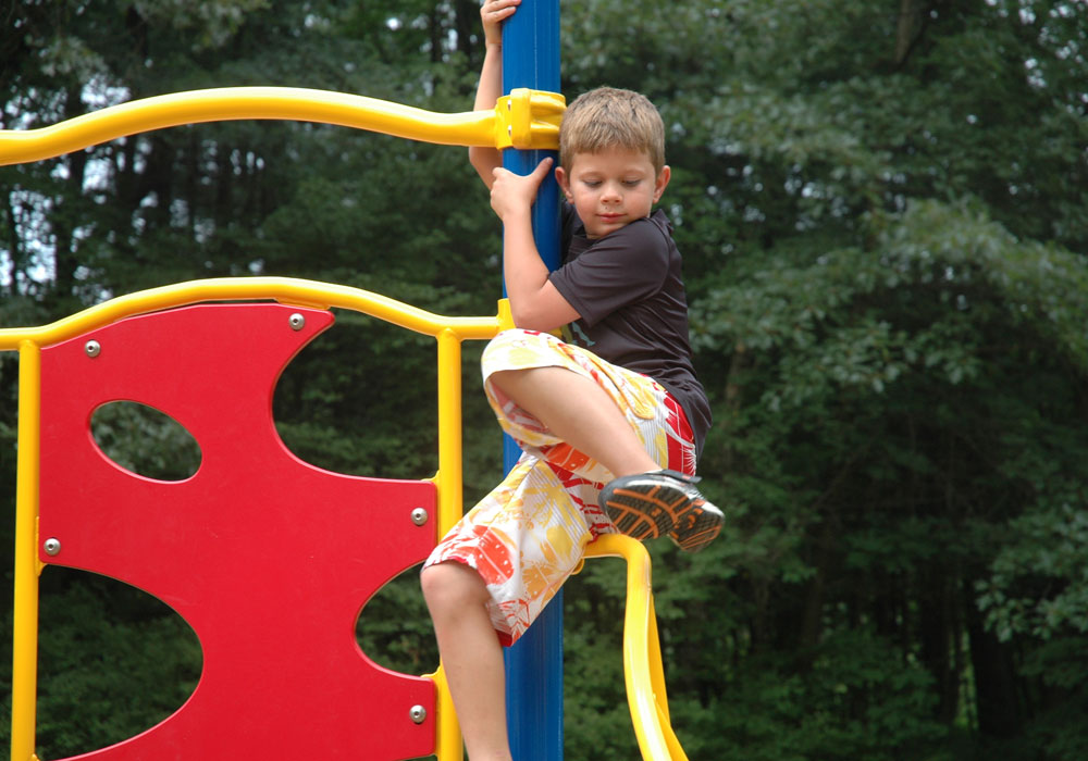 Boy Playing On Playground