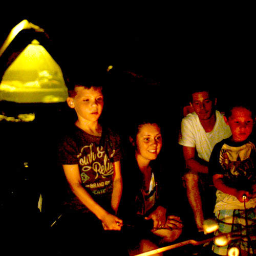 Guests Sitting Around Bonfire